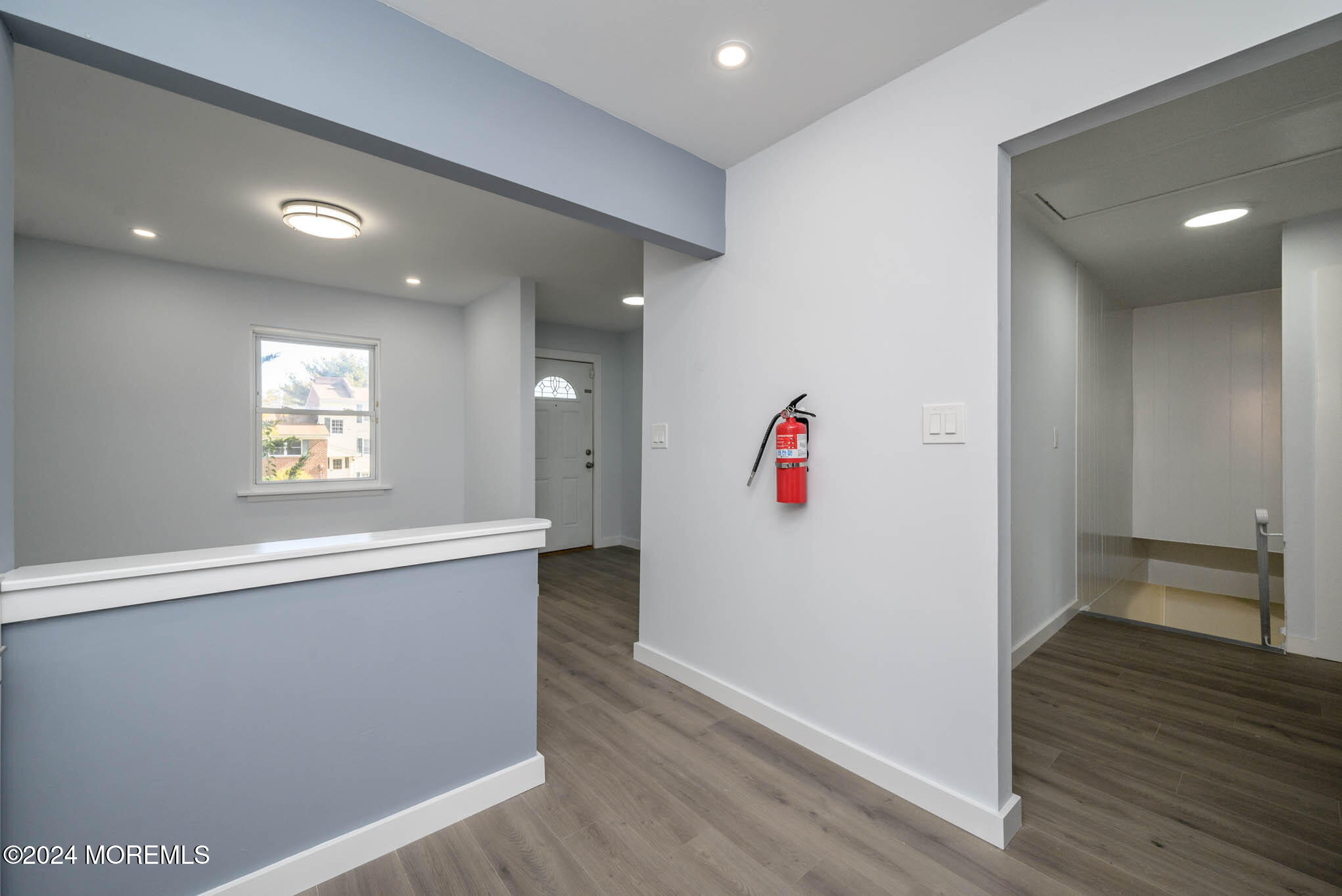 246 Sawmill Road, Unit 403 Brick, NJ 08724 - Photo 12 of 41 a view of an empty room with wooden floor and a window