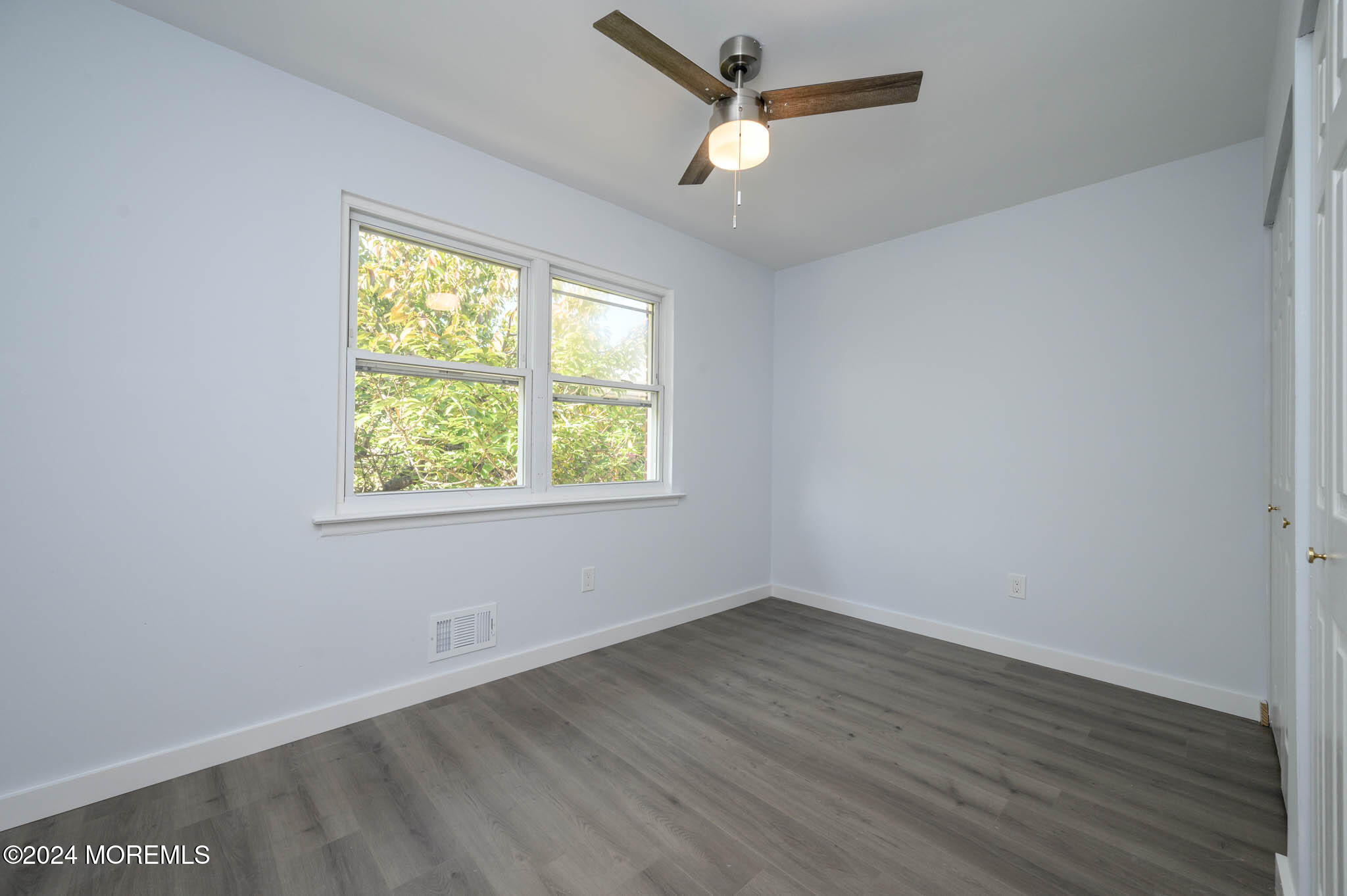 246 Sawmill Road, Unit 403 Brick, NJ 08724 - Photo 19 of 41 an empty room with wooden floor and windows