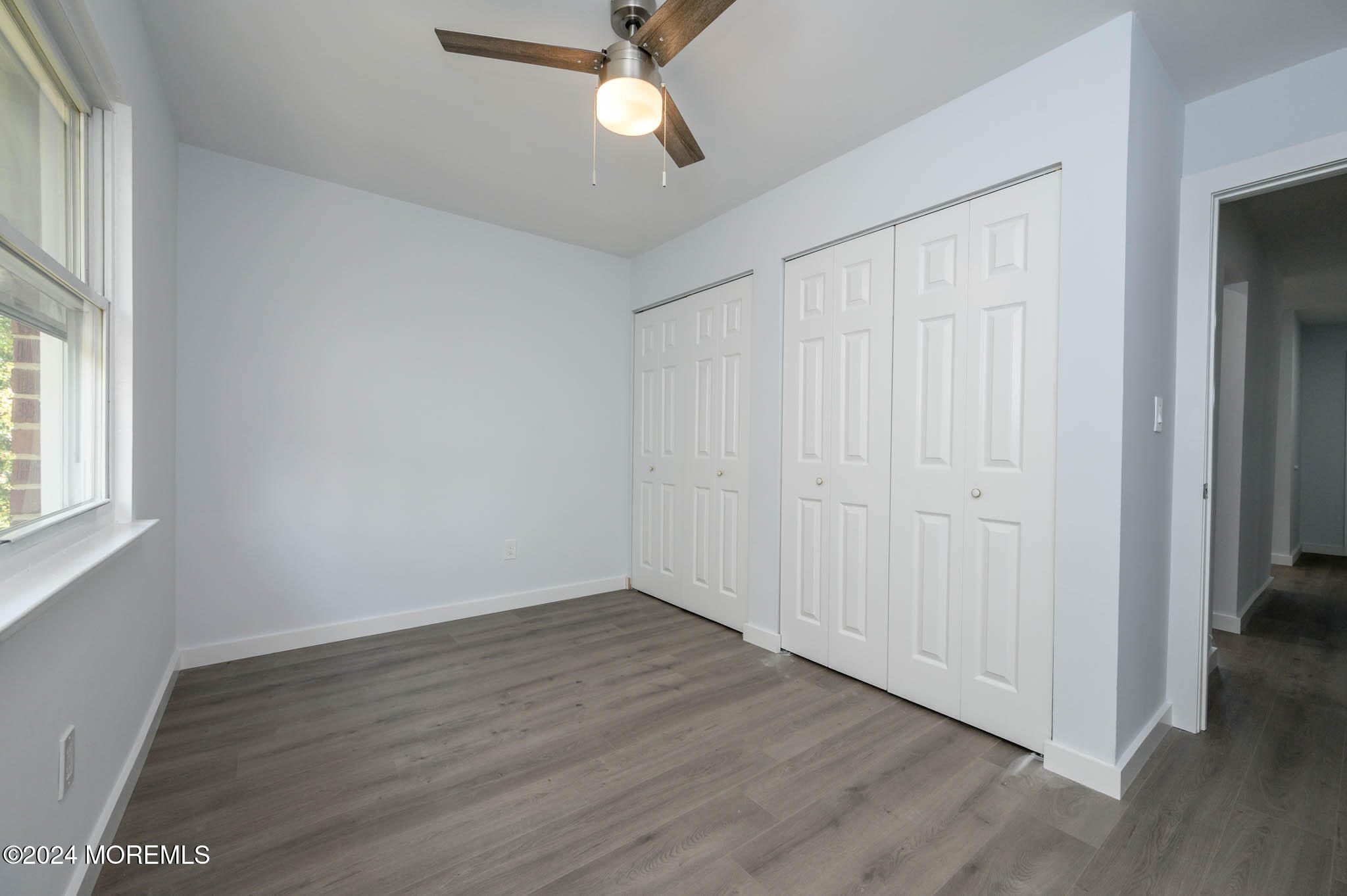 246 Sawmill Road, Unit 403 Brick, NJ 08724 - Photo 20 of 41 a view of an empty room with wooden floor and a window