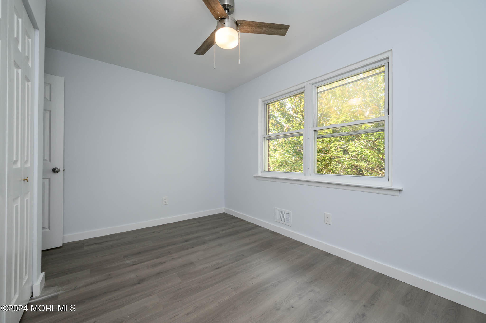 246 Sawmill Road, Unit 403 Brick, NJ 08724 - Photo 22 of 41 an empty room with wooden floor and windows