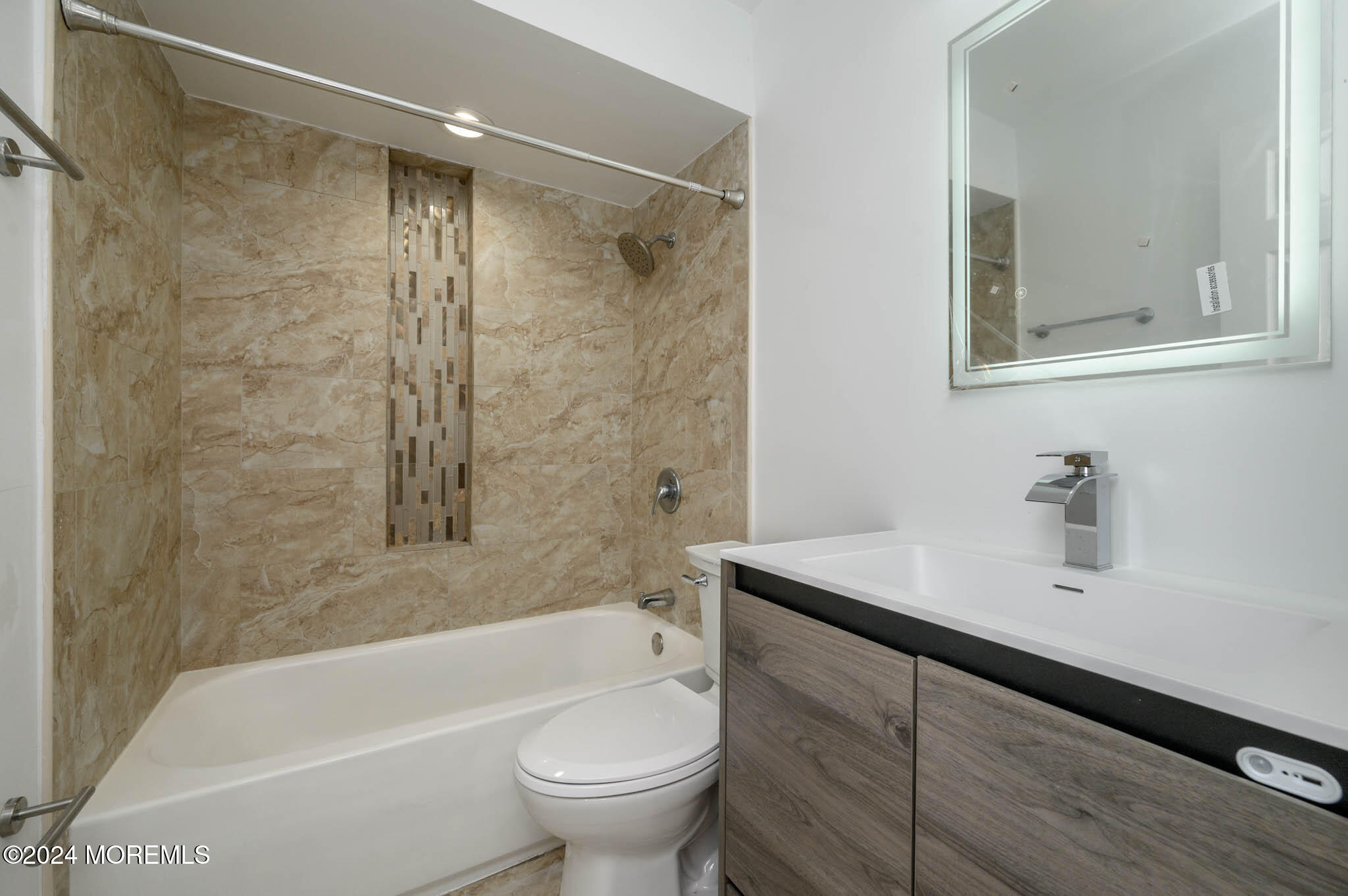 246 Sawmill Road, Unit 403 Brick, NJ 08724 - Photo 23 of 41 a bathroom with a sink mirror toilet and bathtub