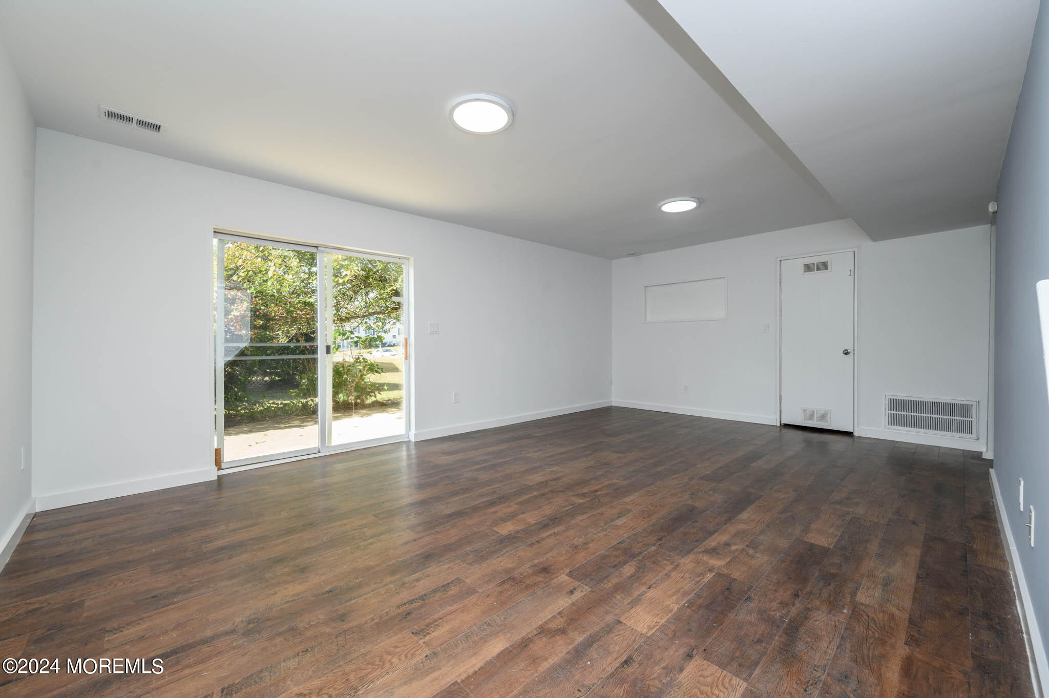 246 Sawmill Road, Unit 403 Brick, NJ 08724 - Photo 28 of 41 a view of an empty room with wooden floor and a window