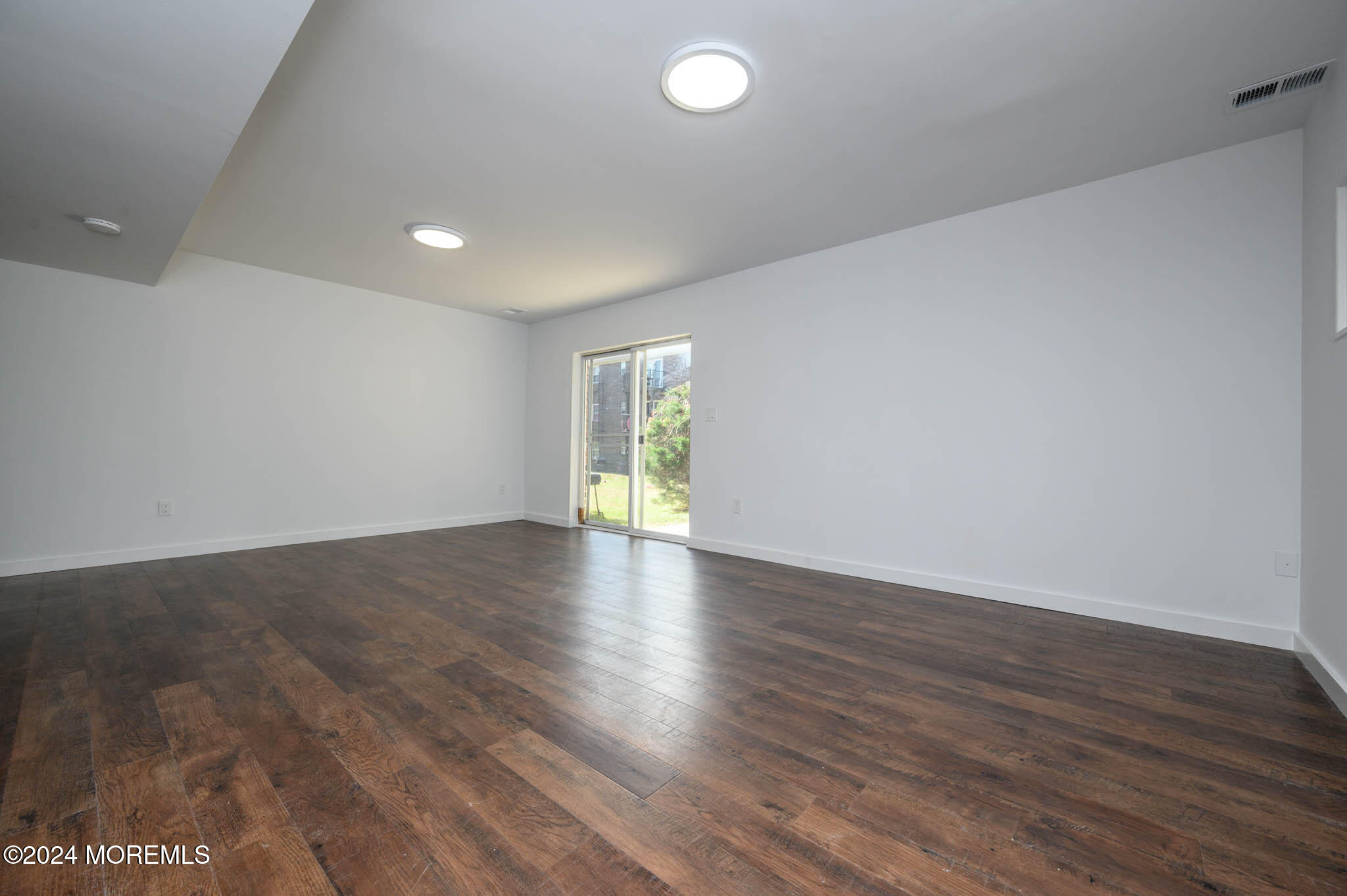 246 Sawmill Road, Unit 403 Brick, NJ 08724 - Photo 31 of 41 a view of an empty room with wooden floor and window