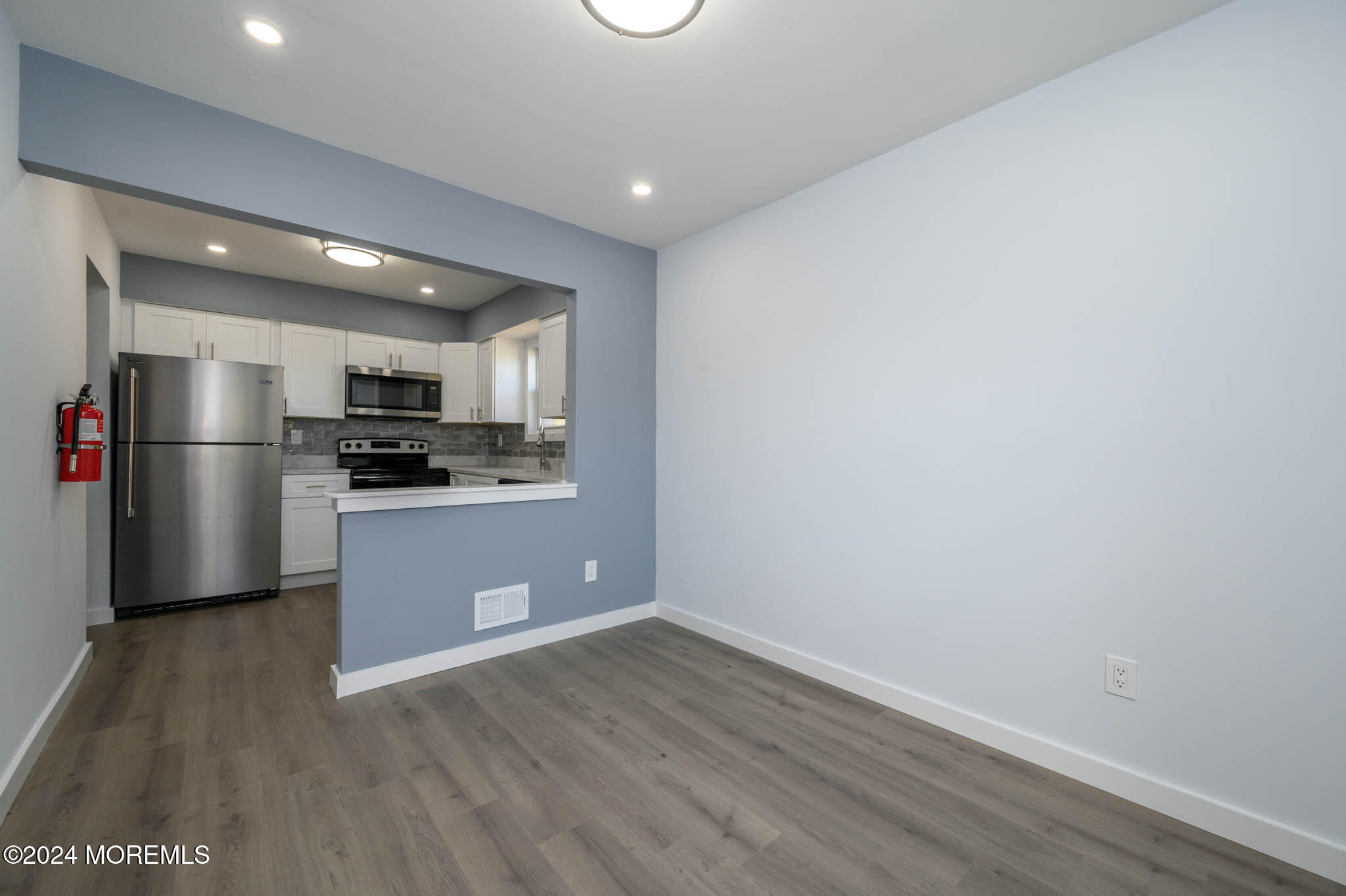 246 Sawmill Road, Unit 403 Brick, NJ 08724 - Photo 5 of 41 a kitchen with a refrigerator and a stove top oven