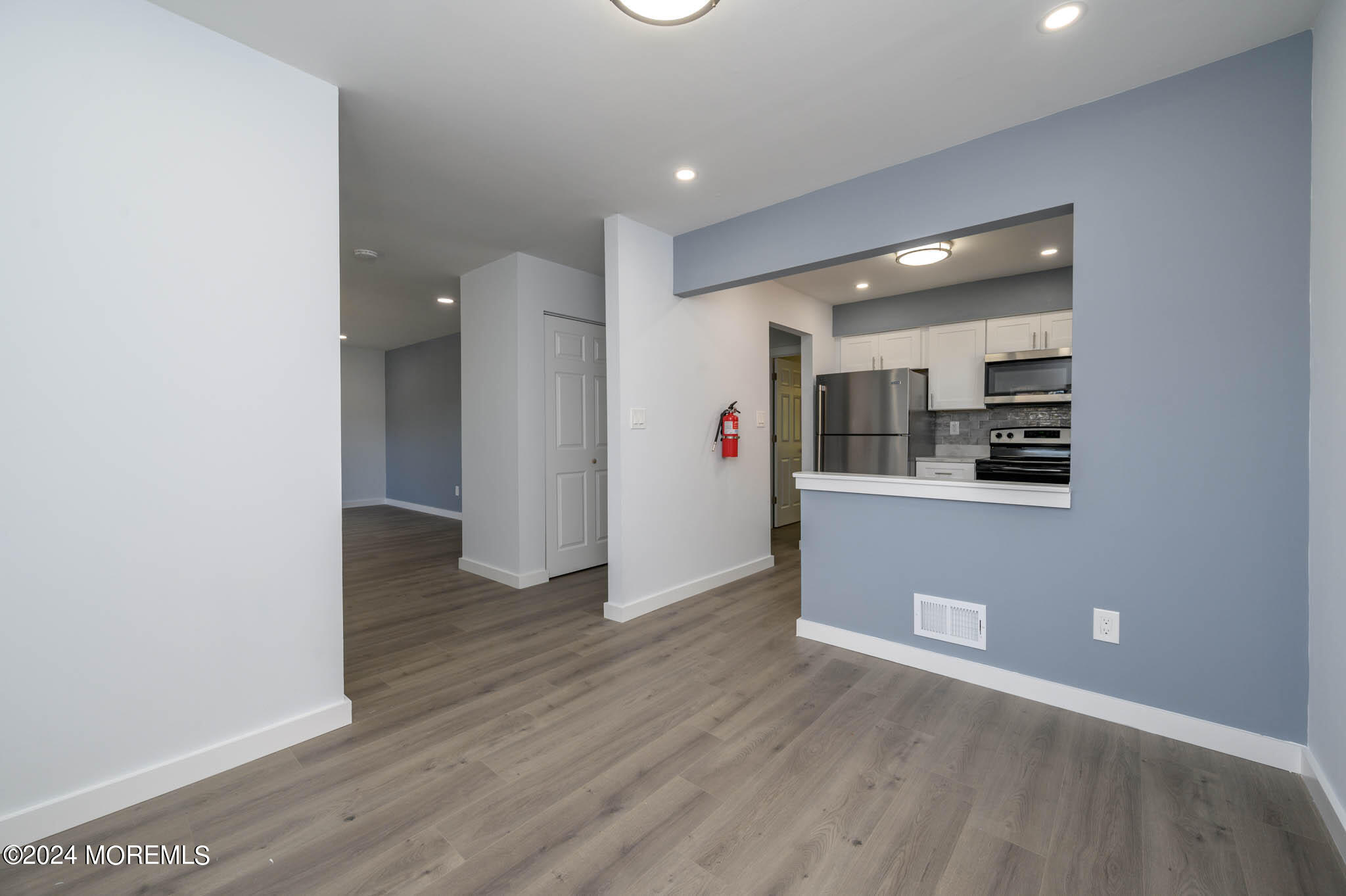 246 Sawmill Road, Unit 403 Brick, NJ 08724 - Photo 6 of 41 an empty room with wooden floor and white walls