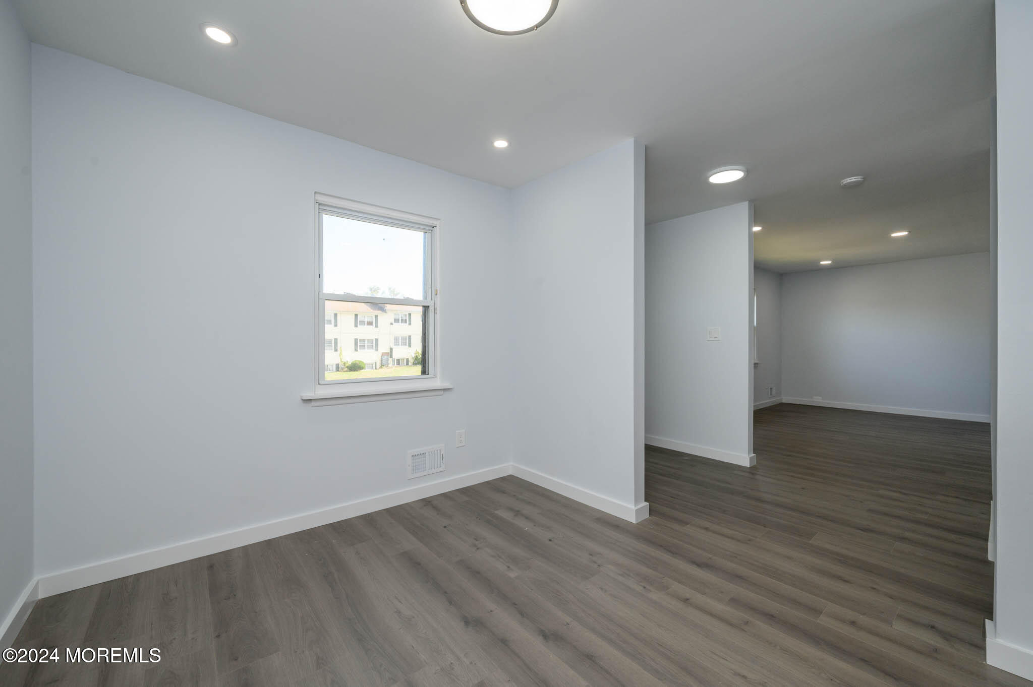246 Sawmill Road, Unit 403 Brick, NJ 08724 - Photo 7 of 41 an empty room with wooden floor and windows