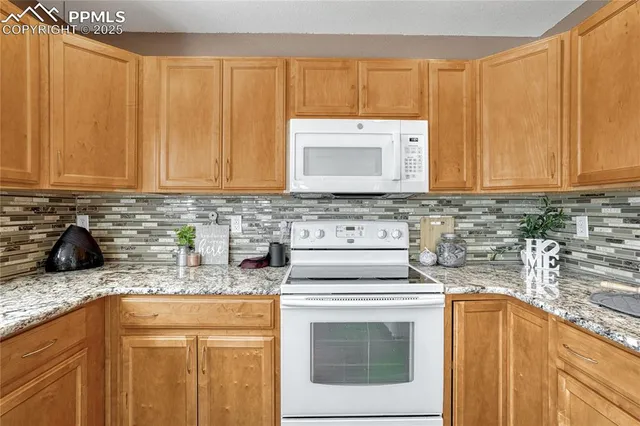 a living room with furniture a table and a fireplace