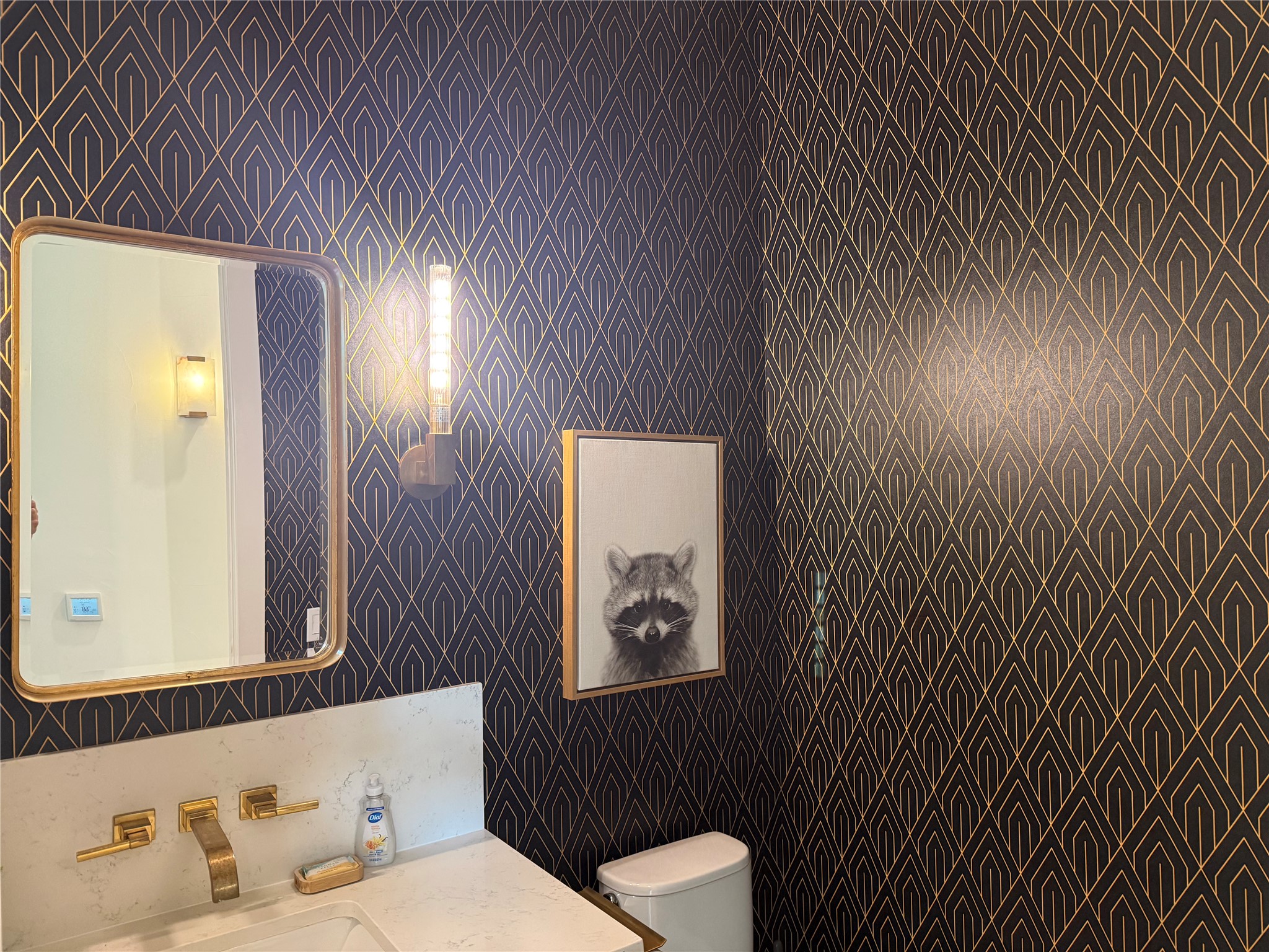 4103 Ridgelea Drive Austin, TX 78731 - Photo 14 of 26 Bold geometric wallpaper and modern brass fixtures define this sophisticated powder room.
