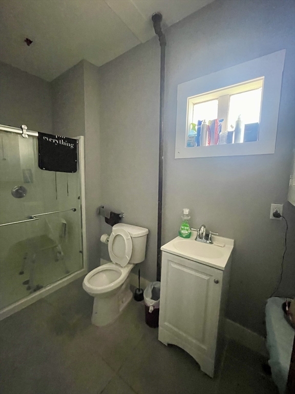 20 Rill Street Boston, MA 02125 - Photo 4 of 20 a bathroom with a toilet sink and mirror