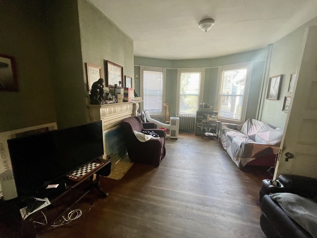 20 Rill Street Boston, MA 02125 - Photo 6 of 20 a living room with furniture gym equipment and a large window