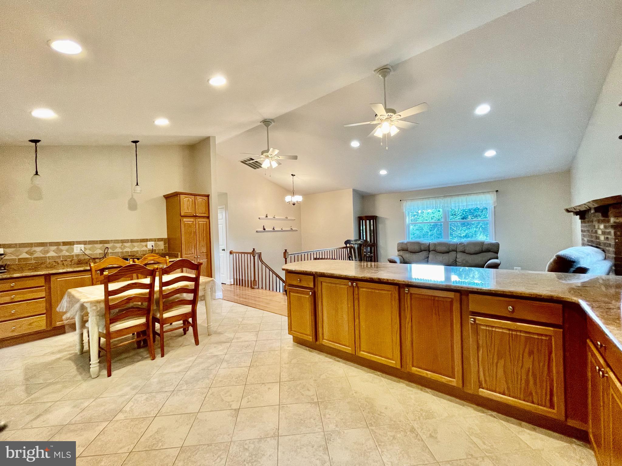 1270 Calvert Beach Road St. Leonard, MD 20685 - Photo 7 of 31 a large kitchen with a large counter top space and stainless steel appliances