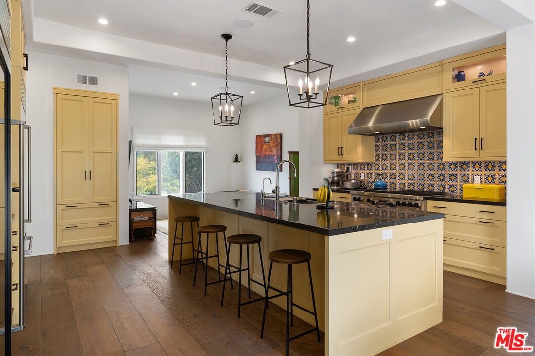 2382 Live Oak Meadows Road Malibu, CA 90265 - Photo 11 of 50 a kitchen with stainless steel appliances a kitchen island hardwood floor and a sink