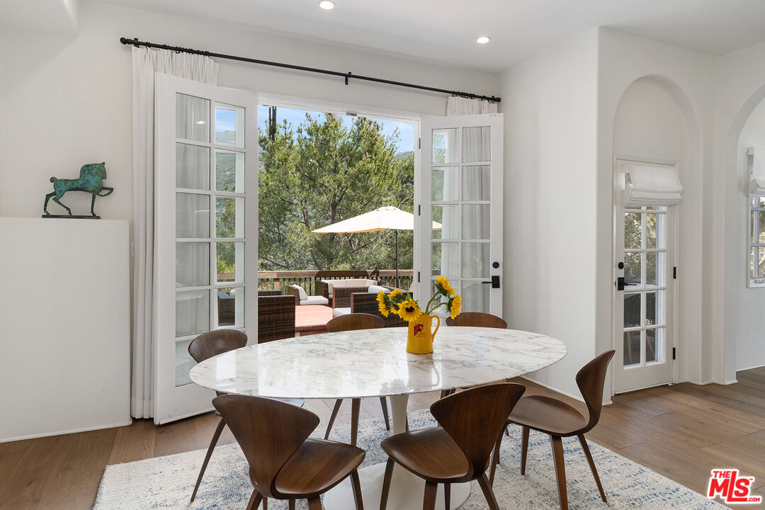 2382 Live Oak Meadows Road Malibu, CA 90265 - Photo 12 of 50 a view of a dining room with furniture and wooden floor