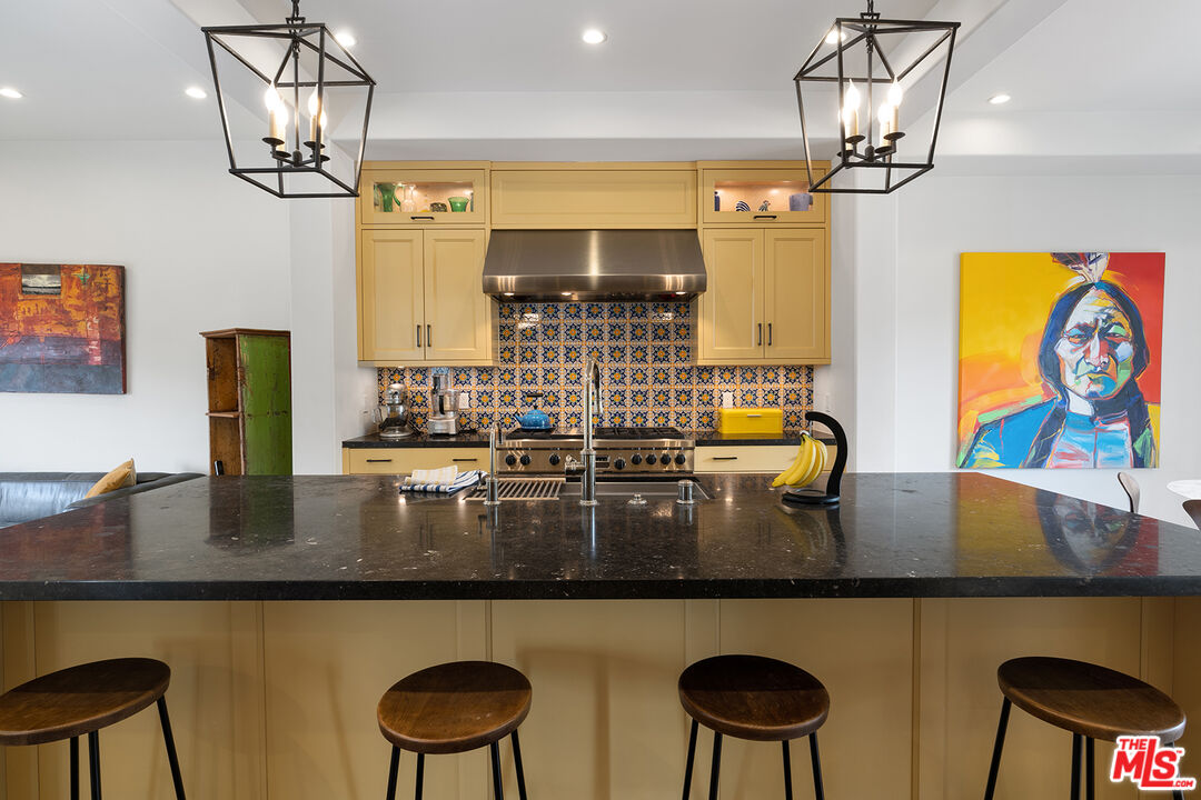 2382 Live Oak Meadows Road Malibu, CA 90265 - Photo 17 of 50 a kitchen with a table chairs and chandelier