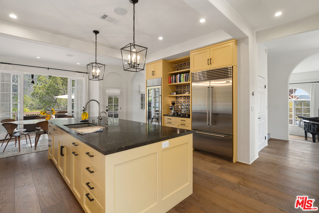 2382 Live Oak Meadows Road Malibu, CA 90265 - Photo 19 of 50 a kitchen with stainless steel appliances granite countertop a sink a stove and a refrigerator