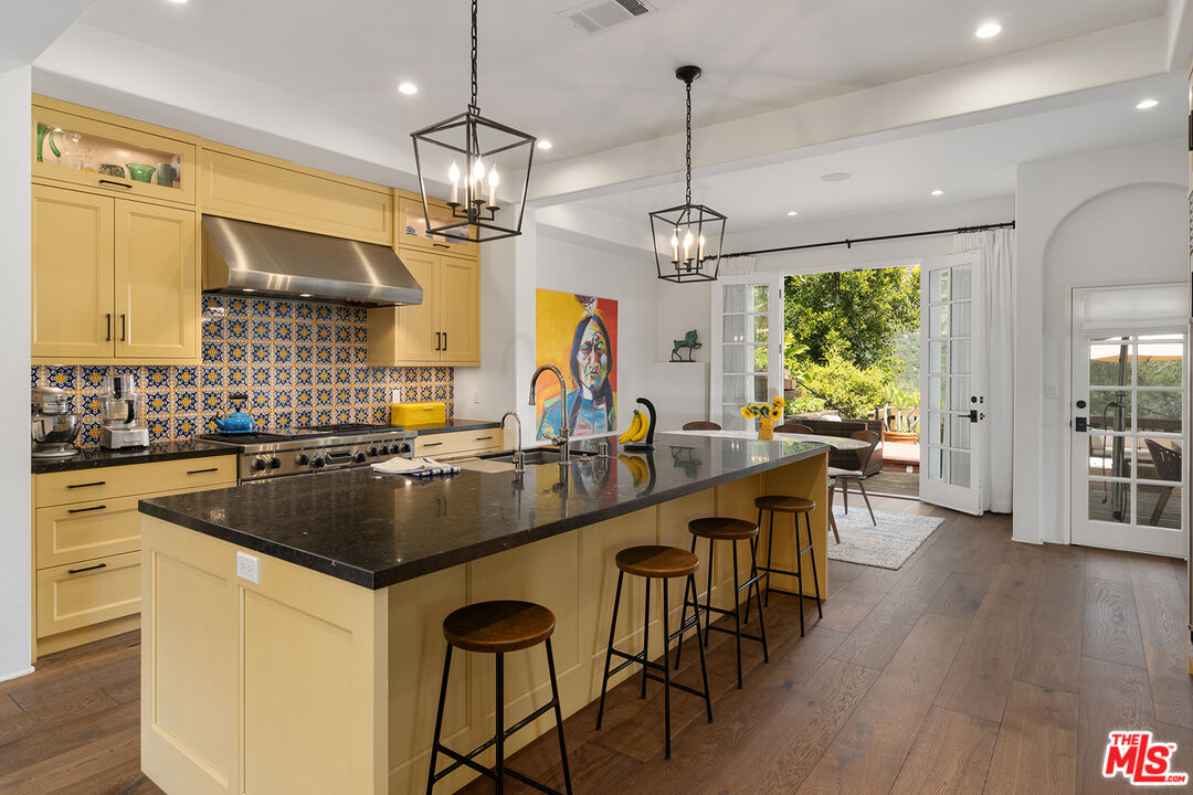 2382 Live Oak Meadows Road Malibu, CA 90265 - Photo 2 of 50 a kitchen with stainless steel appliances granite countertop a stove a refrigerator a kitchen island a island a stove and a wooden floors