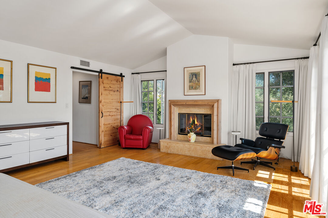 2382 Live Oak Meadows Road Malibu, CA 90265 - Photo 24 of 50 a living room with furniture a rug and a fireplace