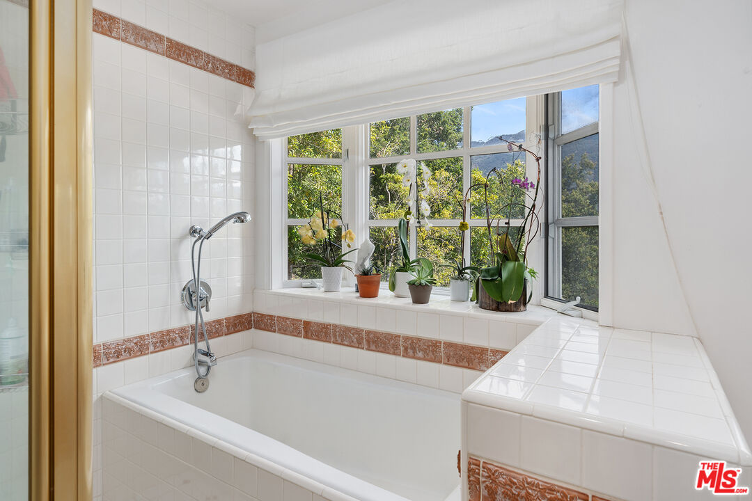 2382 Live Oak Meadows Road Malibu, CA 90265 - Photo 29 of 50 a bathroom with a bathtub and window