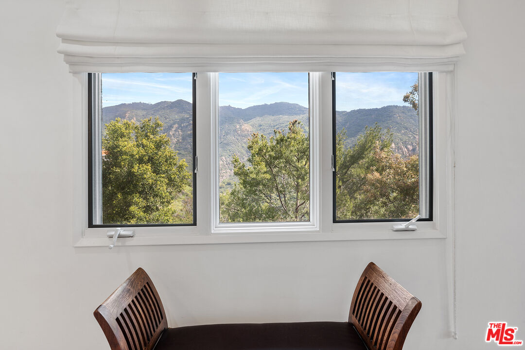 2382 Live Oak Meadows Road Malibu, CA 90265 - Photo 30 of 50 a view of a door and chair and floor in a bedroom