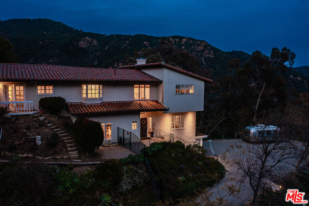 2382 Live Oak Meadows Road Malibu, CA 90265 - Photo 3 of 50 a front view of a house with a yard and a fountain