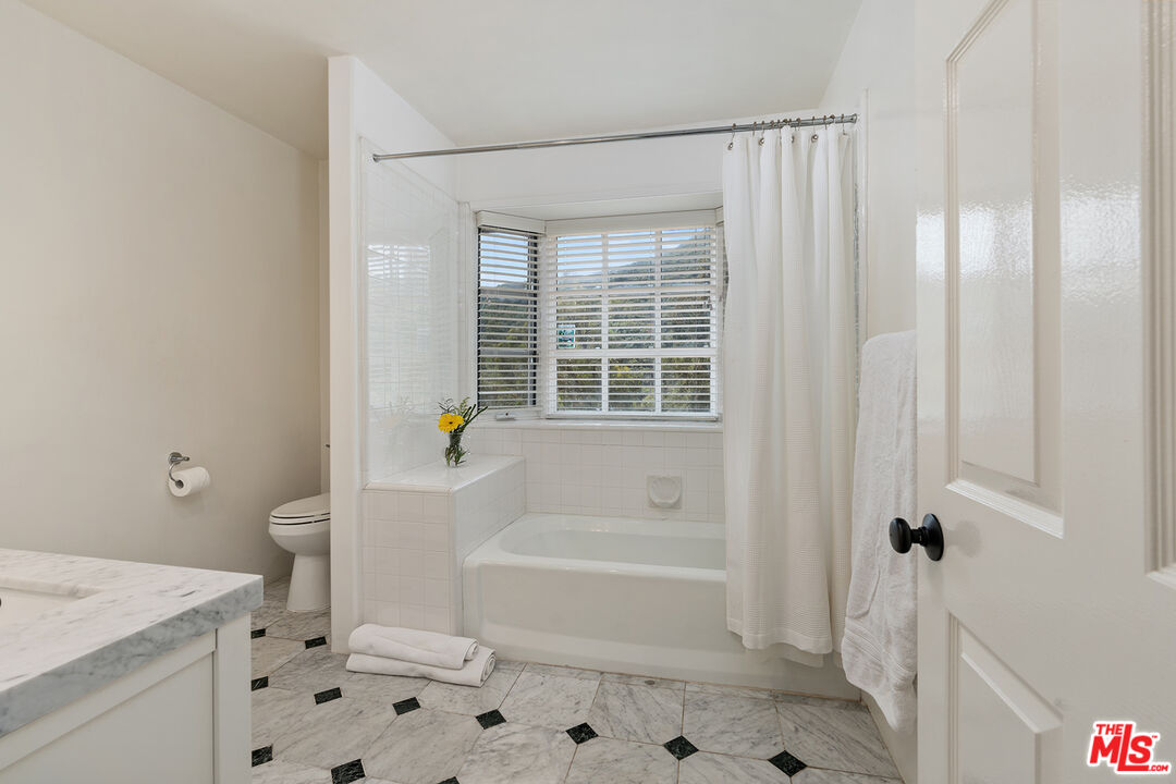 2382 Live Oak Meadows Road Malibu, CA 90265 - Photo 32 of 50 a bathroom with a bathtub a toilet a sink and a shower