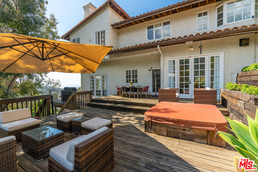 2382 Live Oak Meadows Road Malibu, CA 90265 - Photo 40 of 50 a view of a patio with couches chairs and wooden floor