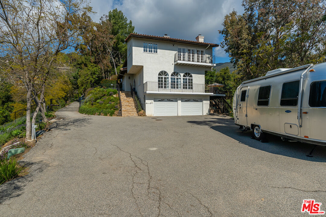 2382 Live Oak Meadows Road Malibu, CA 90265 - Photo 47 of 50 a front view of a house with a yard