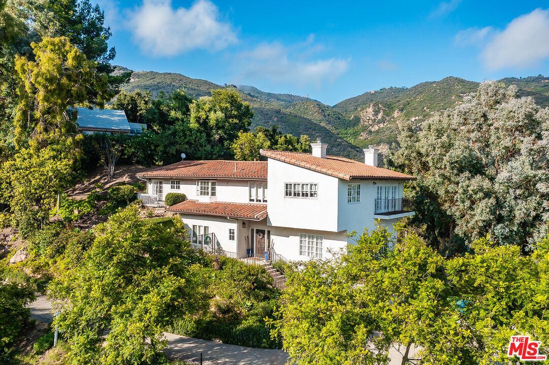2382 Live Oak Meadows Road Malibu, CA 90265 - Photo 49 of 50 a view of a building in front of a garden