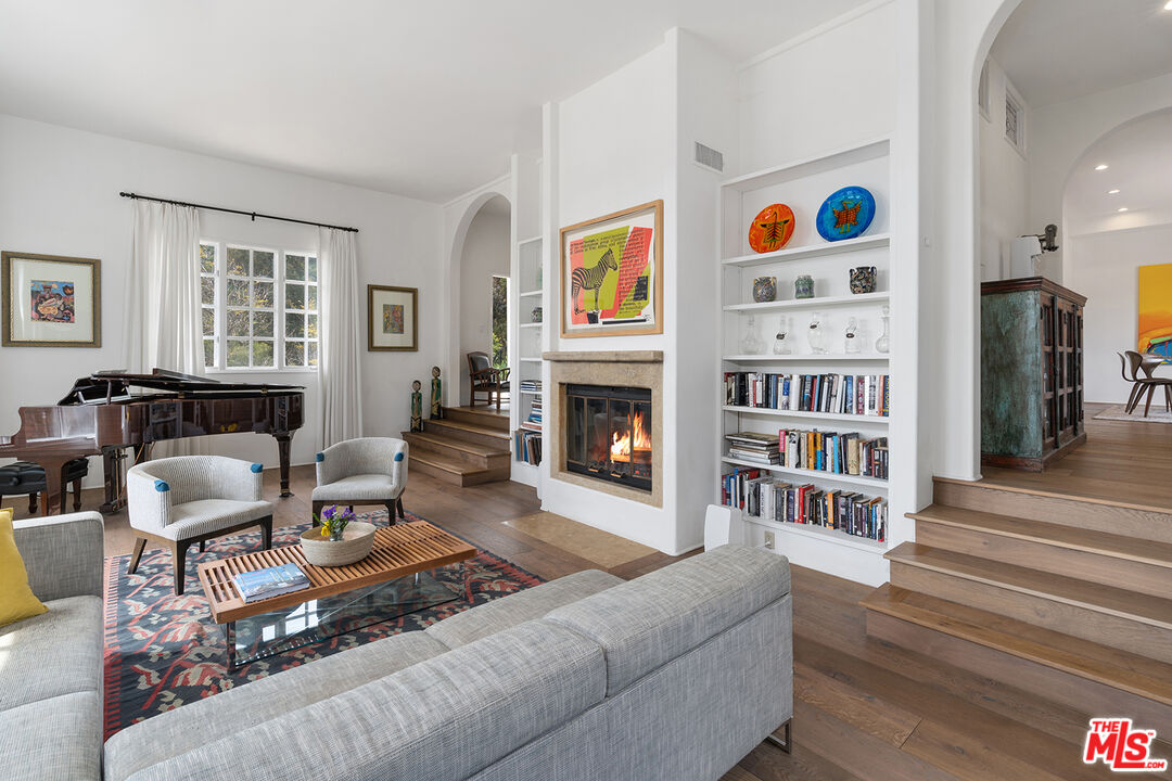2382 Live Oak Meadows Road Malibu, CA 90265 - Photo 7 of 50 a living room with furniture and a book shelf