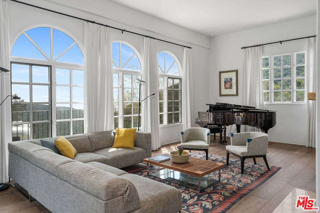 2382 Live Oak Meadows Road Malibu, CA 90265 - Photo 8 of 50 a living room with furniture and floor to ceiling windows