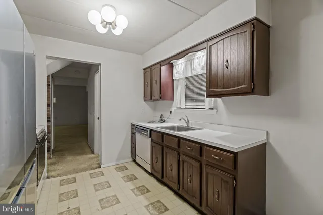 a kitchen with a sink a stove and refrigerator