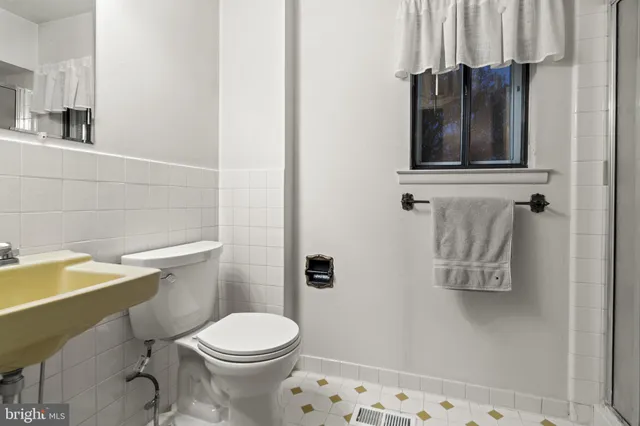 a bathroom with a shower and a glass door