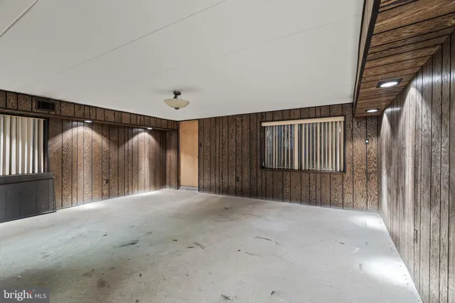 a view of hallway with wooden walls