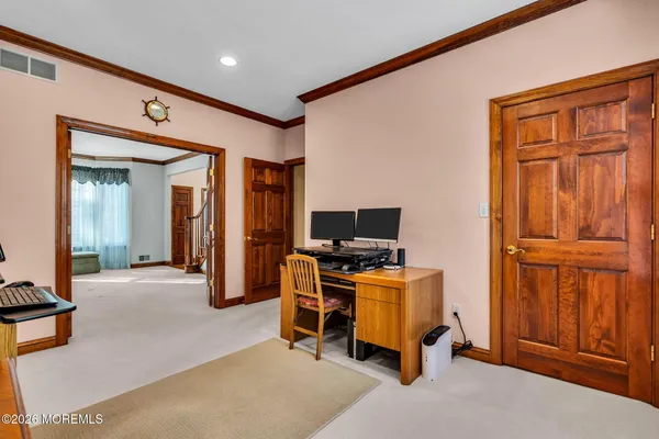 a dining room with furniture wooden floor a rug and a chandelier