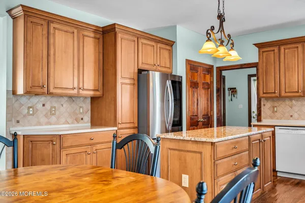 a kitchen with stainless steel appliances granite countertop a stove and a refrigerator
