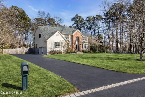 a front view of house with yard and green space