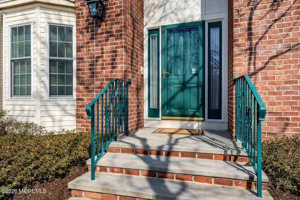 a view of an entryway with wooden floor and stairs