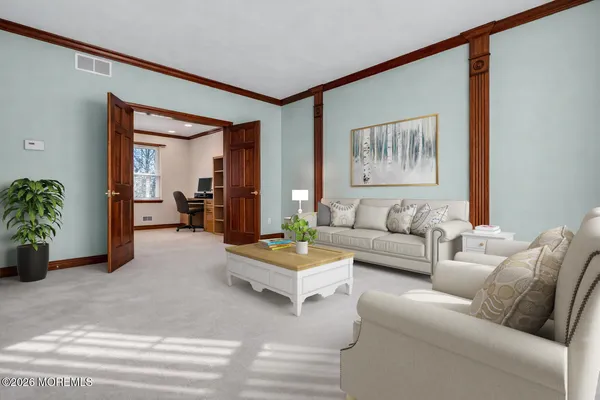 a livingroom with workspace and a window