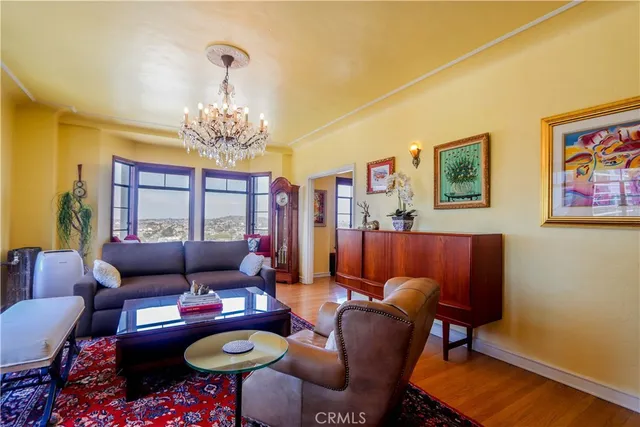 a living room with furniture and a chandelier