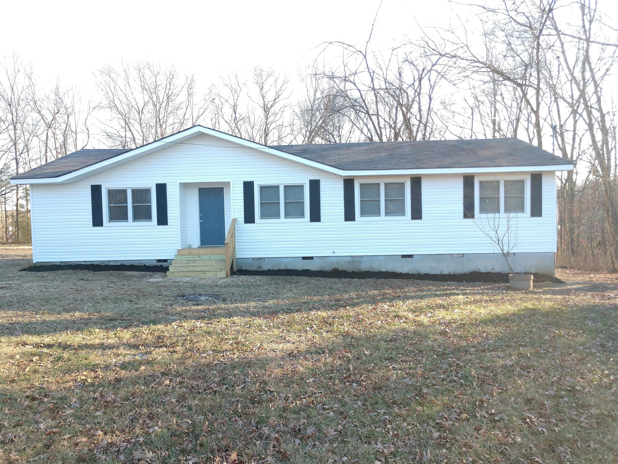 1240 Black Road Cunningham, TN 37052 - Photo 1 of 12 a house that has a lot of windows in it