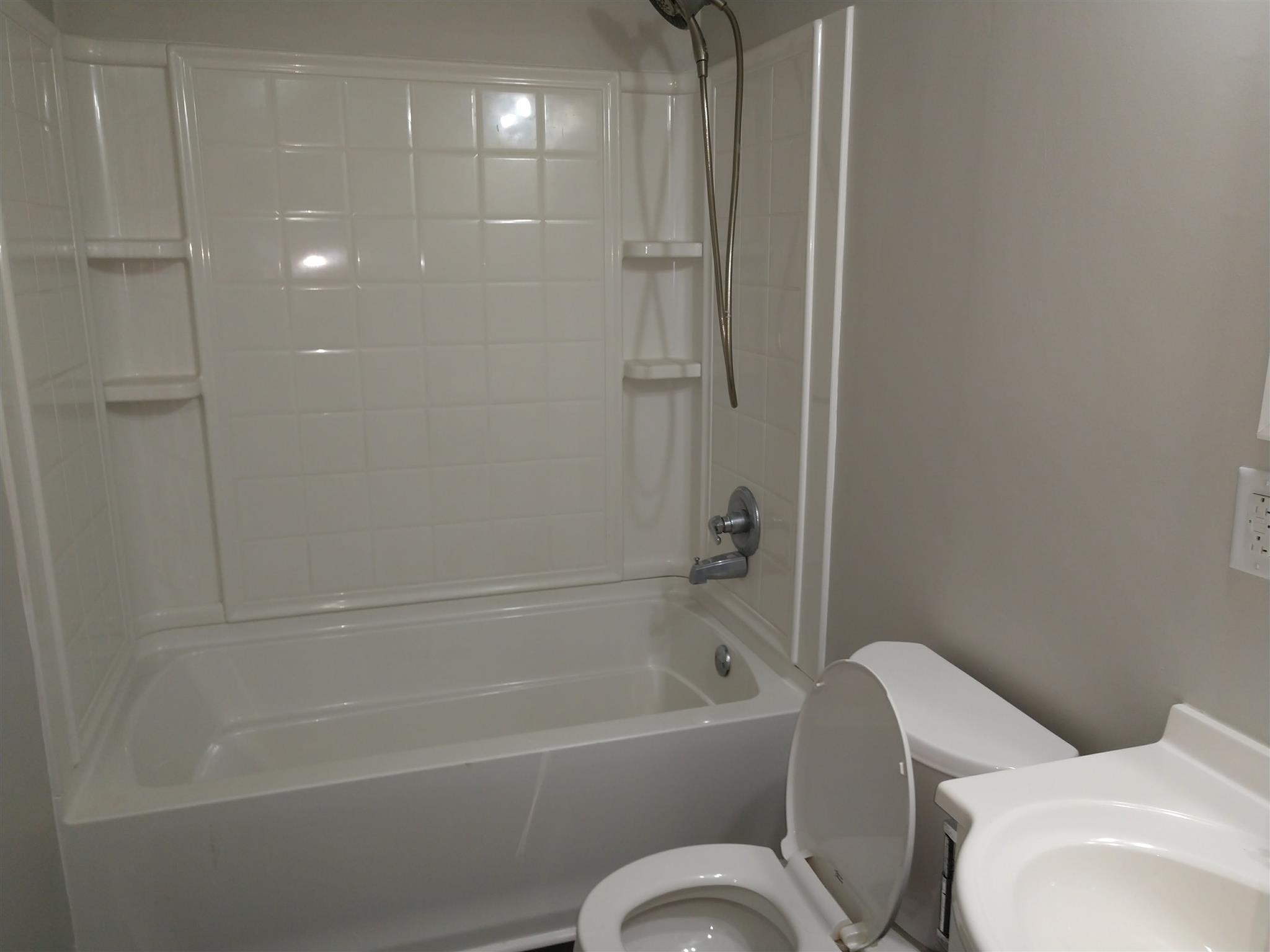 1240 Black Road Cunningham, TN 37052 - Photo 6 of 12 a bathroom with a toilet bathtub and shower