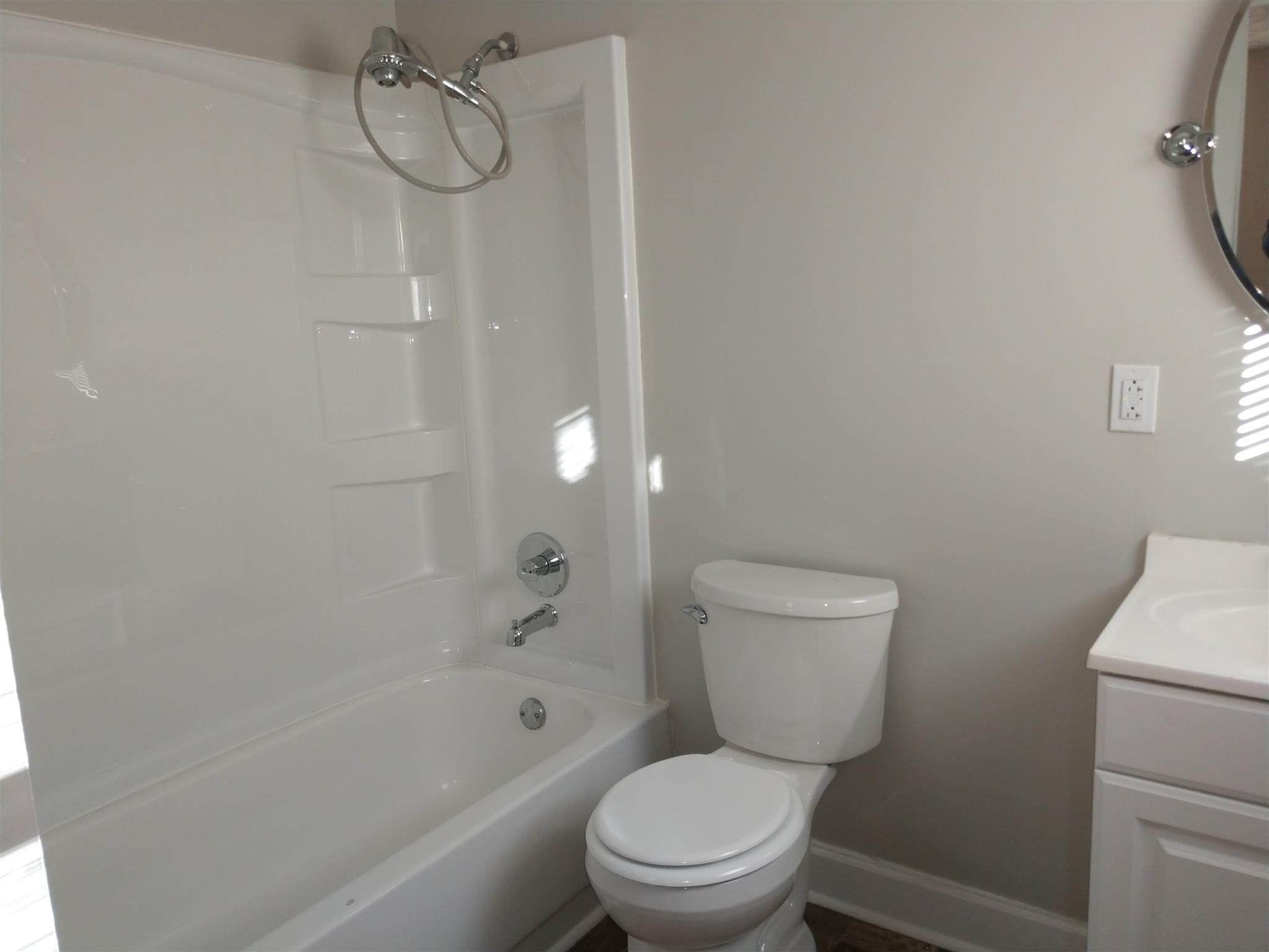 1240 Black Road Cunningham, TN 37052 - Photo 9 of 12 a white toilet sitting next to a bath tub