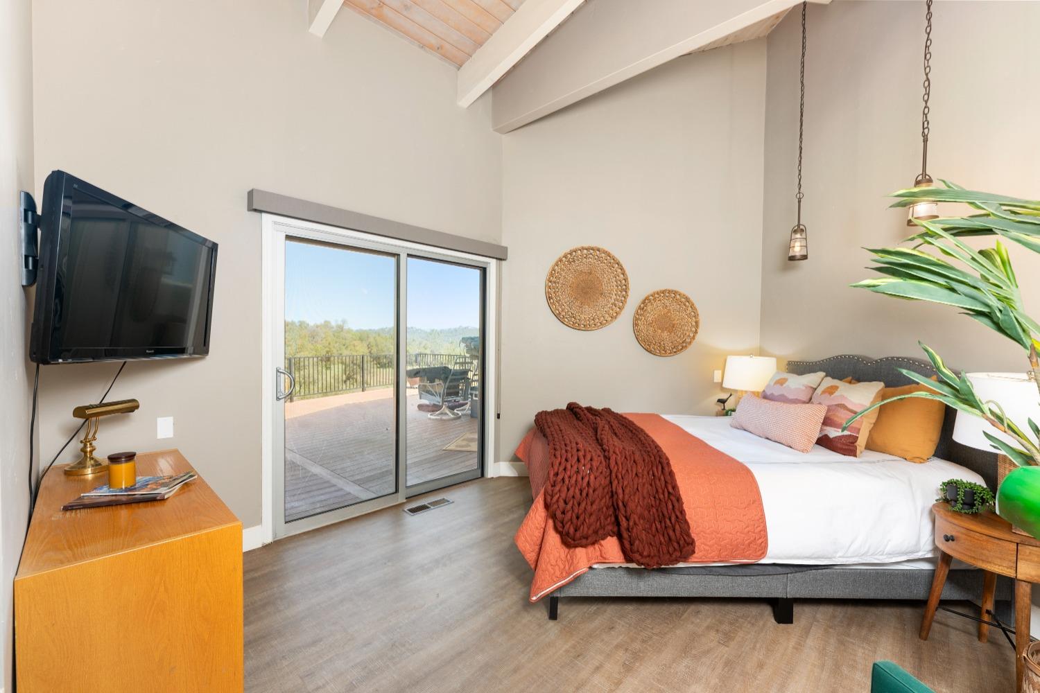 5161 Coyote Pass Road Shingle Springs, CA 95682 - Photo 12 of 48 a bedroom with a bed and flat screen tv