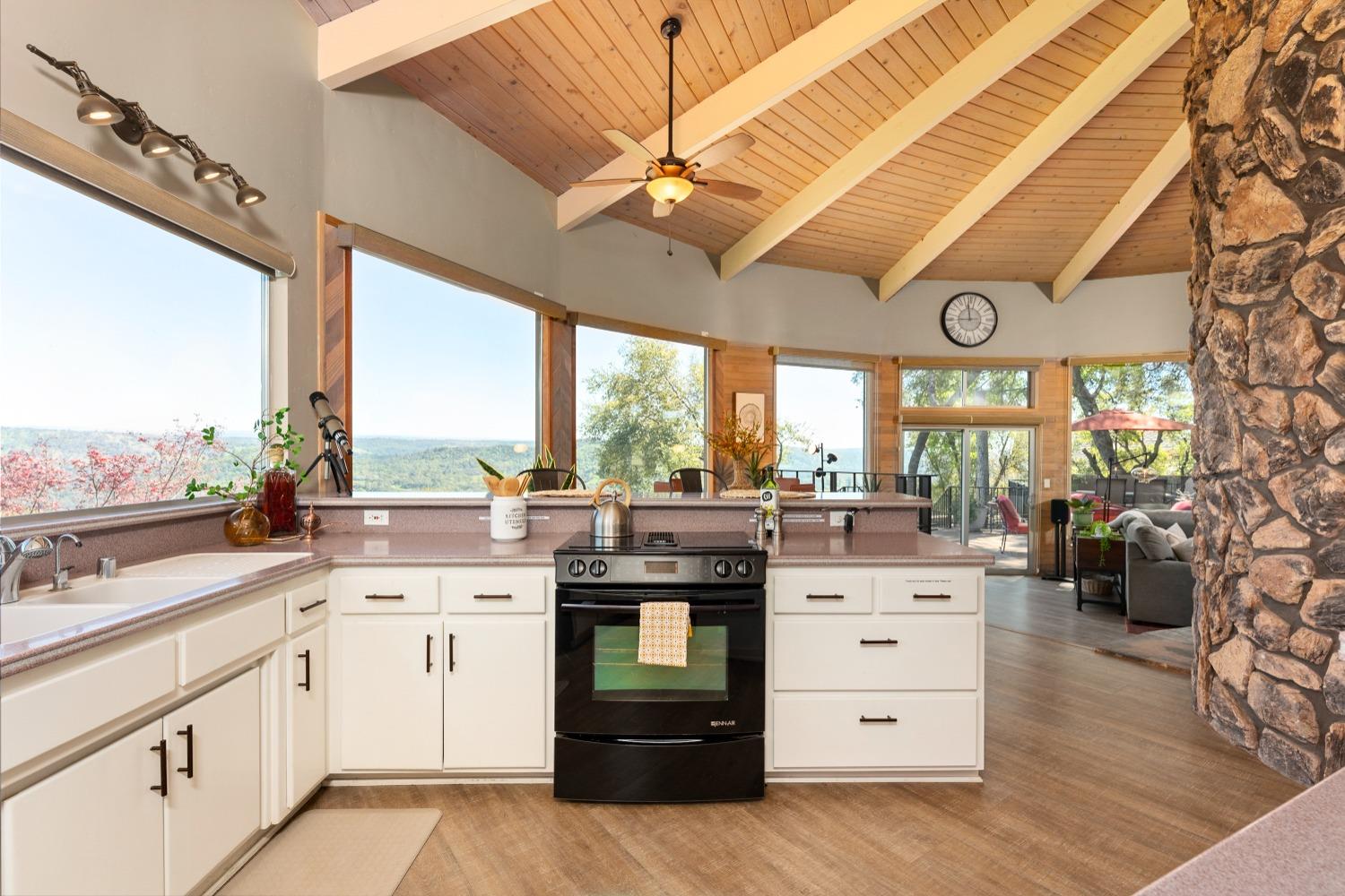5161 Coyote Pass Road Shingle Springs, CA 95682 - Photo 15 of 48 a kitchen with a stove a sink and a large window