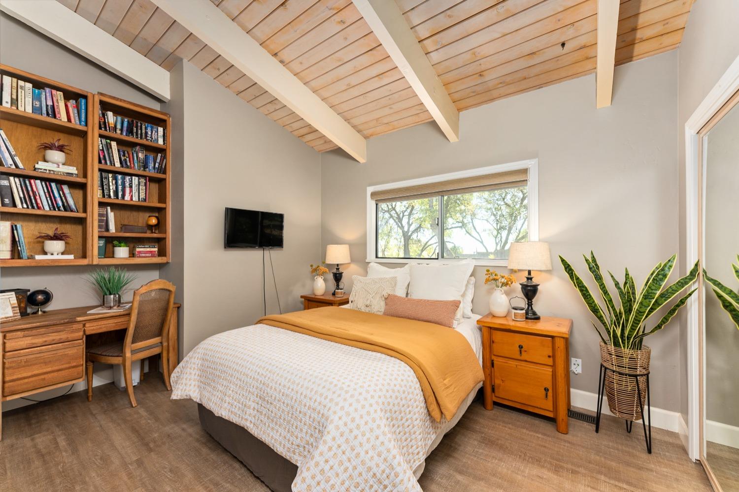 5161 Coyote Pass Road Shingle Springs, CA 95682 - Photo 18 of 48 a bedroom with a bed a book shelf and a window