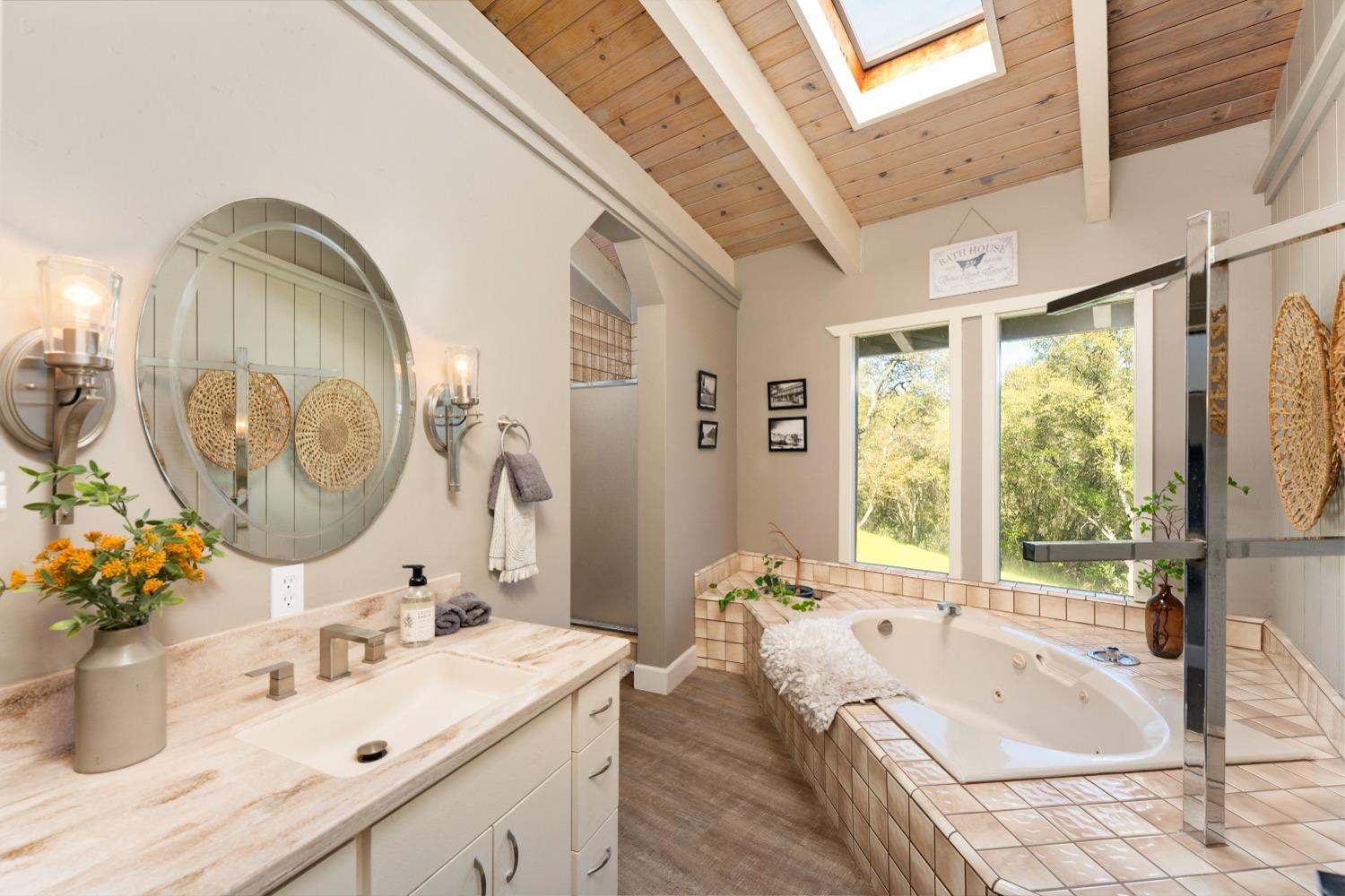 5161 Coyote Pass Road Shingle Springs, CA 95682 - Photo 19 of 48 a bathroom with a tub sink and mirror