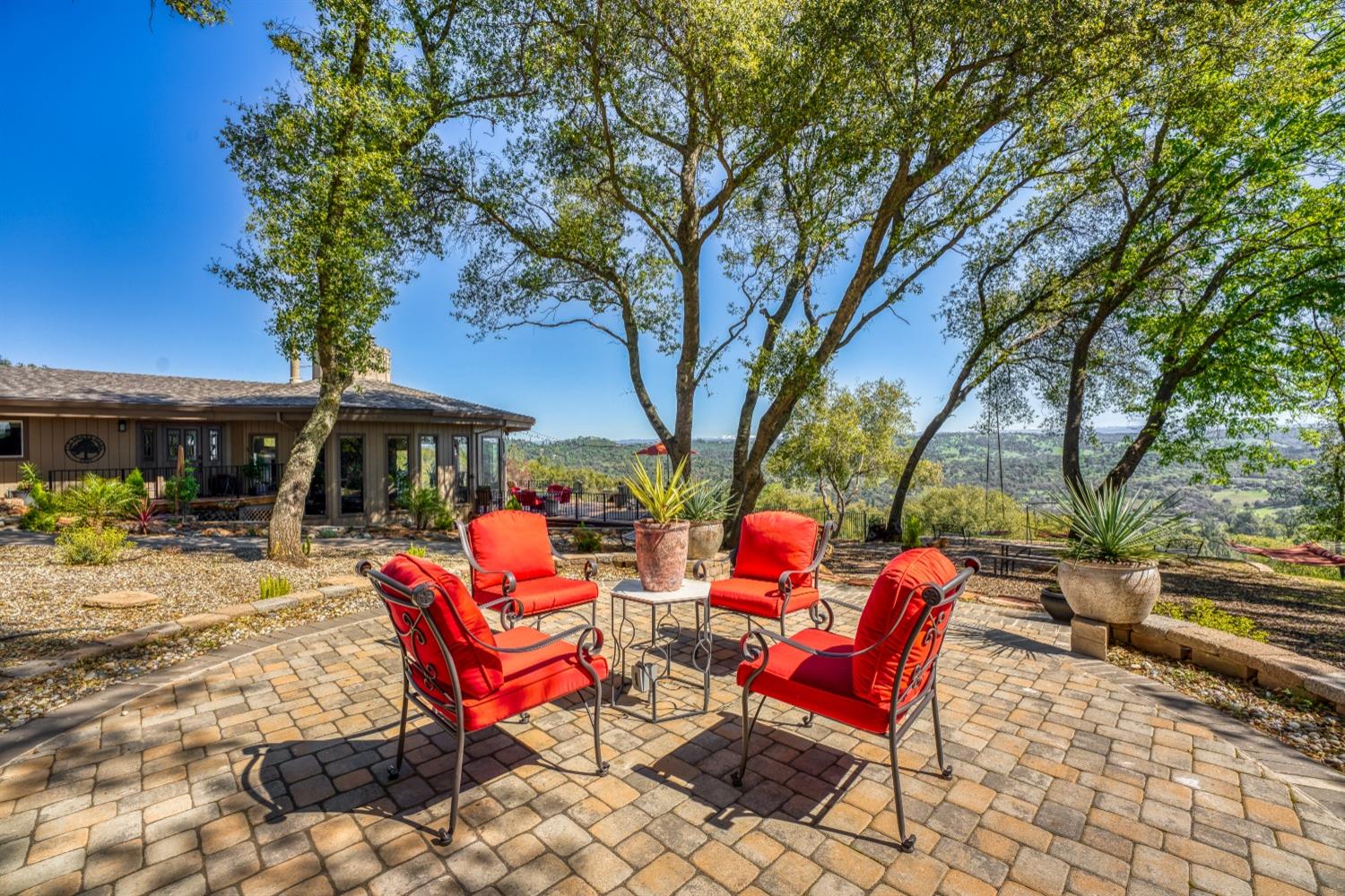5161 Coyote Pass Road Shingle Springs, CA 95682 - Photo 28 of 48 a backyard of a house with barbeque oven table and chairs