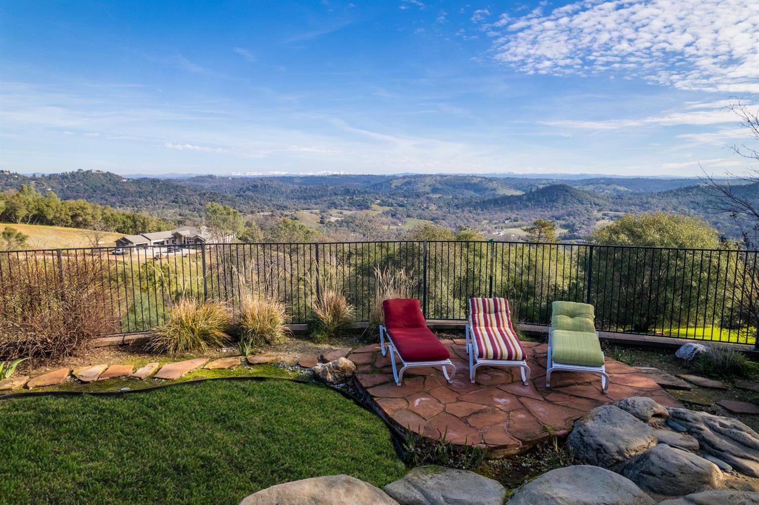 5161 Coyote Pass Road Shingle Springs, CA 95682 - Photo 4 of 48 a view of a lake with a chairs in patio