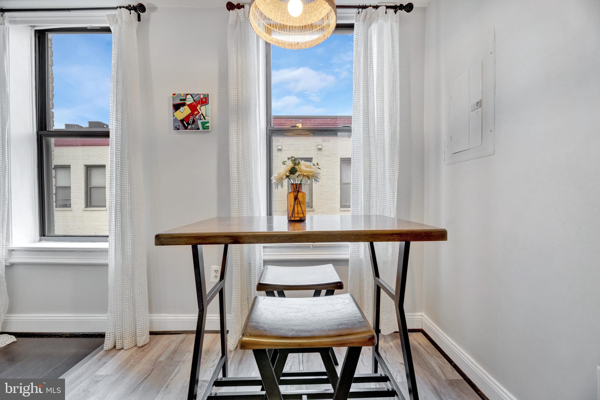 1436 W Street Northwest, Unit 405 Washington, DC 20009 - Photo 5 of 13 a view of a dining room with furniture and wooden floor