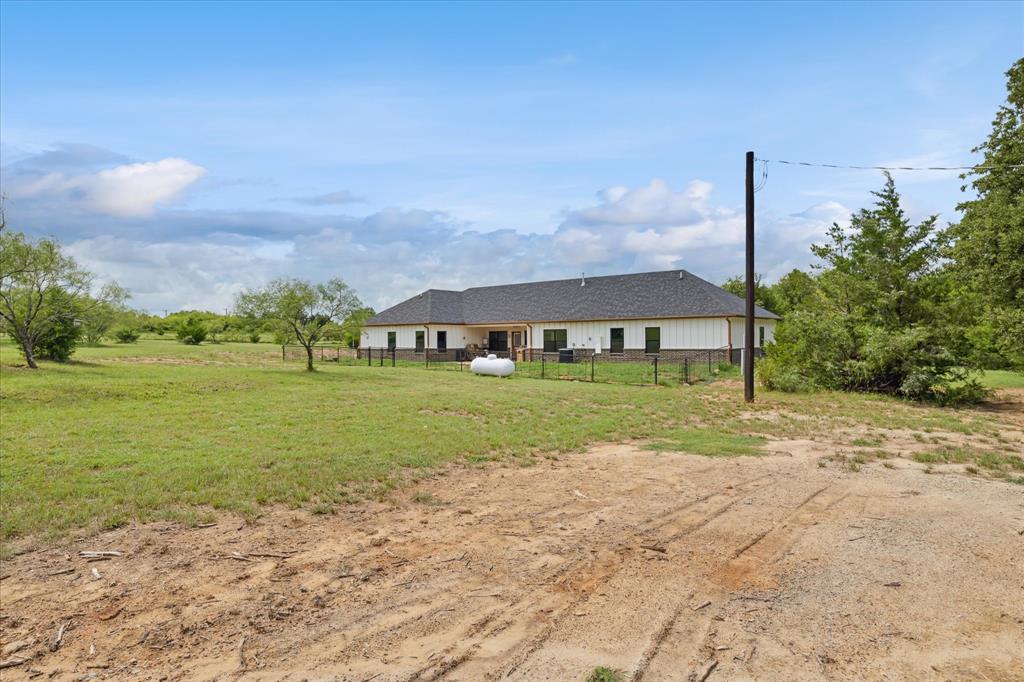 403 Polk Road Bowie, TX 76230 - Photo 26 of 36 a view of a house with a big yard